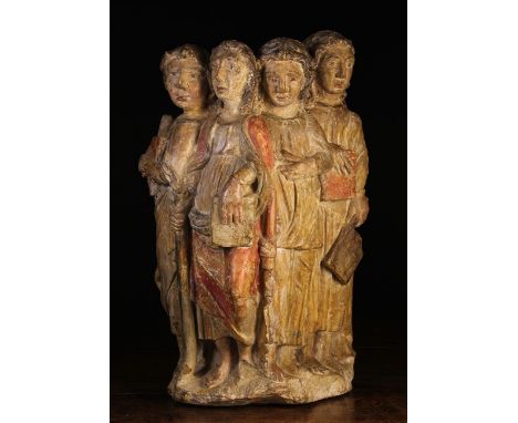 A Late 15th/Early 16th Century Polychromed Stone Carving of four figures holding books and tools of trade, 20 ins (51 cms) hi