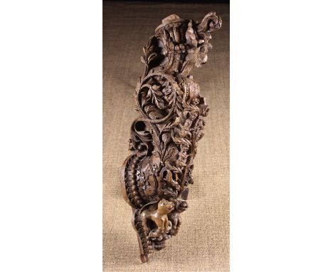A Late 16th/Early 17th Century Ornamental Architectural Bracket intricately carved from wood with a scrolling body entwined i