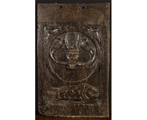 A Good 16th Century English Oak Panel carved with a devil's head in a roundel above a fish, 17½ ins x 11 ins (45 cms x 28 cms