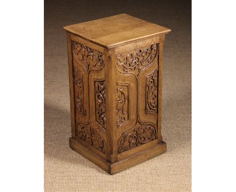An Oak Pedestal. The near square top above Gothic carved panel sides (one side left open). The three parchemin panels enriche