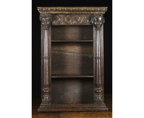 A Small 19th Century Oak Hanging Shelf Unit. The open shelves below a foliate carved frieze. The pilasters with applied split