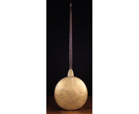 A 17th/Early 18th Century Brass Warming Pan.  The hinged, slightly domed lid pierced with perforations and nail-punched with 