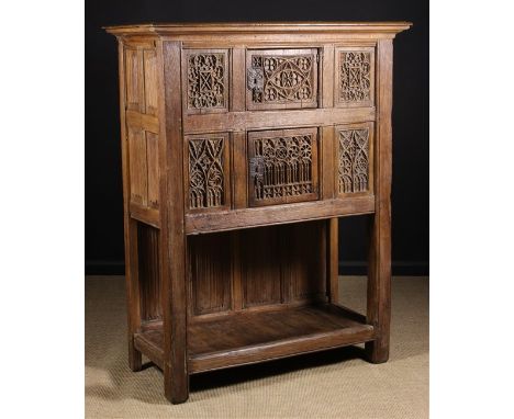 A French Carved Oak Gothic Style Dressoir having two cupboards set one above another flanked by side panels intricately carve