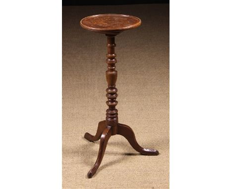 A Late Georgian Oak Tripod Candle Stand. The circular top edged in moulding and fixed to a multi-knopped columns on outswept 