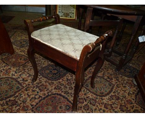 A stained Satinwood framed piano stool standing on canted cabriole legs and having turned side handles, the upholstered seat 