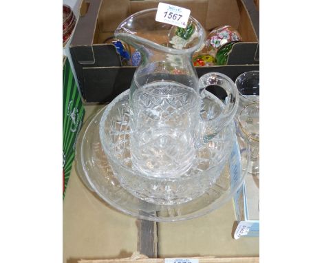 A cut glass jug and trifle bowl, etched fruit dish and frosted leaf design platter.