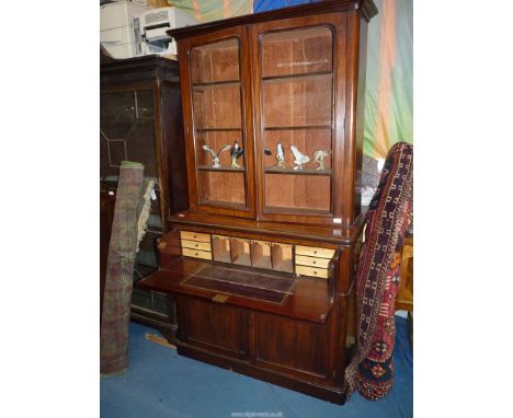 A late 19th c. Secretaire Bookcase, the upper pair of opposing glazed doors enclosing adjustable bookshelving and the base ha