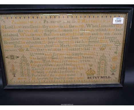 A framed and glazed 'Psalm Sampler' by Betsy Mill, 19 3/4'' x 12 1/4''.