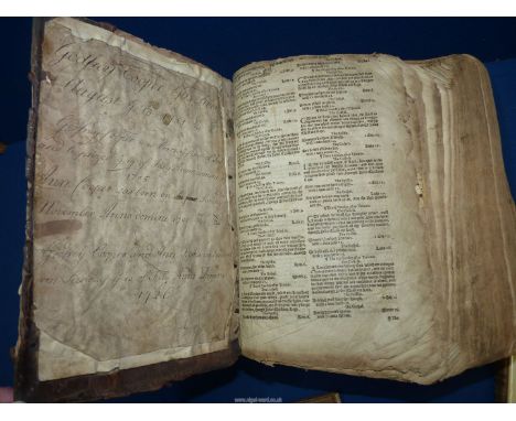 A distressed leather bound Geneva/"Breeches" Bible bound with the book of Common Prayer, a card note therewith states: "A Gen