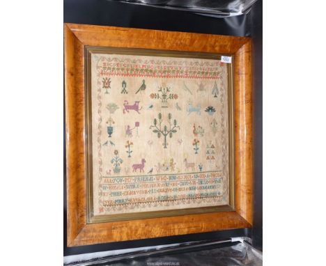 A Maple framed and glazed sampler by Mary Rutherford, aged 11, June 1806, M.M Griger, G.R Reins, showing stylised animals, tr