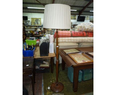 A standard lamp with pleated shade.