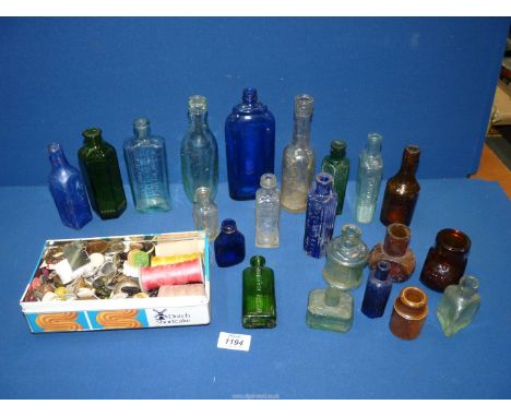A box of old vintage bottles including poison and blue glass bottles and a tin of old buttons.