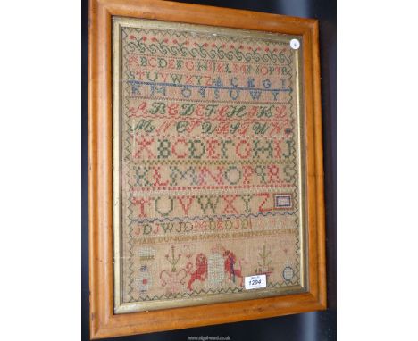 A Maple framed and glazed sampler by Mary Duncan, Kirkintel Loch, 1856 showing a Lion and Unicorn and the alphabet, 12'' wide