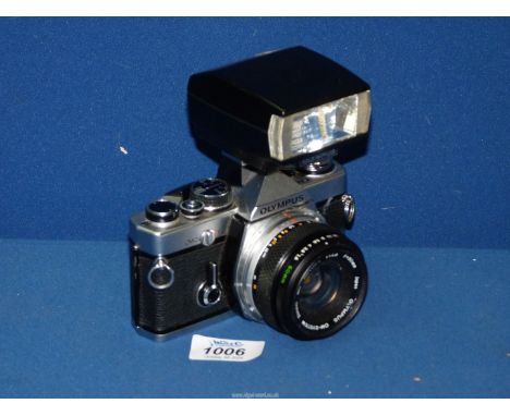 An Olympus OM-2 film camera 50 mm F1.8 with T20 Olympic flash.