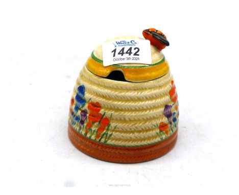 A Clarice Cliff honey pot in 'Crocus' pattern.