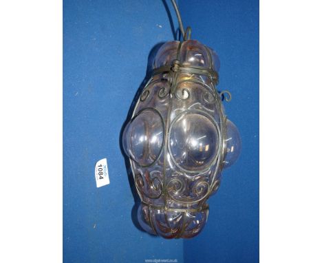 A 'caged' blown pink glass light shade, 12'' long.