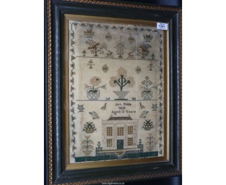 A framed and glazed sampler by Ann Pride, aged 12, 1828 in silk detailing a Regency house, deer, birds, butterflies with a st