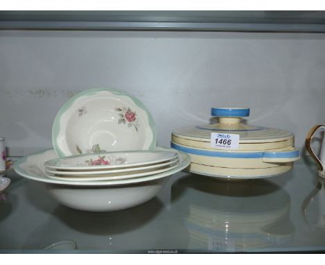 A Clarice Cliff fruit set for four with pink roses and green borders, plus a lidded serving dish with blue and gold circles.