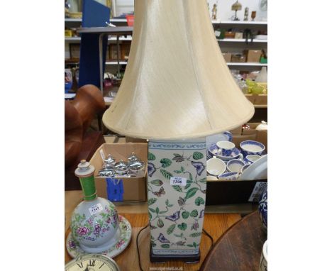 A tall ceramic table lamp, square shape with butterfly and foliage decoration, with shade, 27" tall incl. shade.