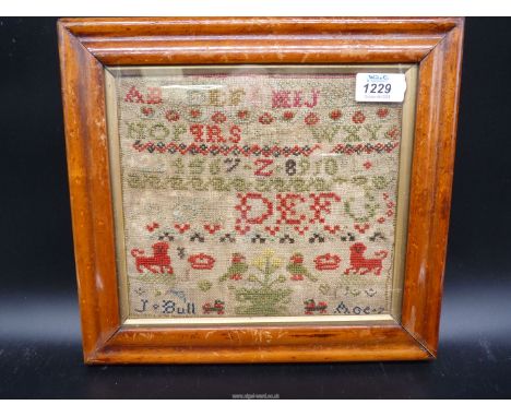 A small alphabet and motifs sampler by J. Bull, aged 7,