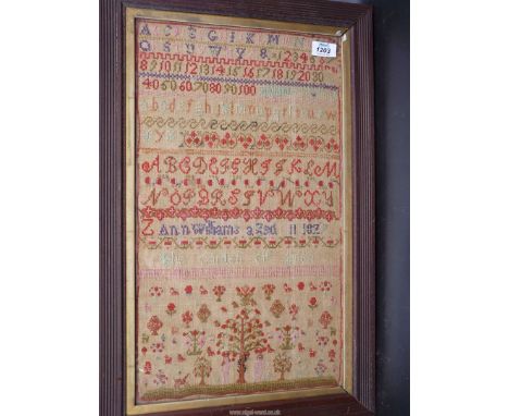 A framed and glazed sampler by Ann Williams aged 11, 1827 showing the Garden of Eden, Adam and Eve, fruit on a tree with a sn