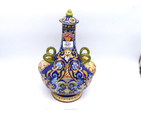 A large French Faience flask and lid having grotesque decoration.