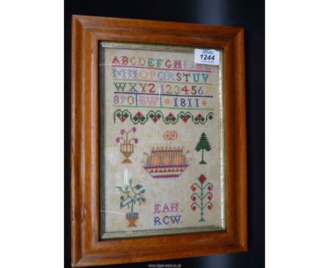 A Maple framed small sampler by B.W, 1811, with parents' initials, E.A.W and R.C.W, alphabet and cross stitch, 6 1/2'' x 10''