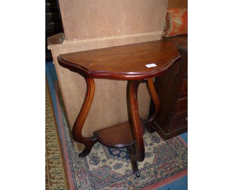 A small Oak side Table having shaped legs united by a lower shelf, 24 1/2'' wide x 12 3/8'' deep x 29 1/4'' high.