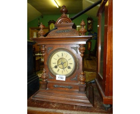A Mantle clock with Junghens movement, 9 1/2" wide x 16" tall, with key and pendulum.
