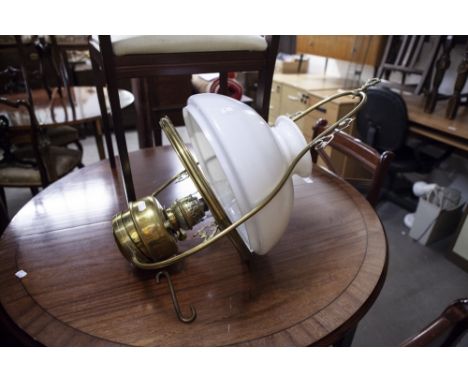 A BRASS OIL HANGING LIGHT WITH OPAQUE GLASS SHADE AND FUNNEL 