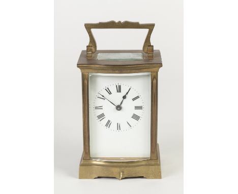 EARLY TWENTIETH CENTURY FRENCH GILT METAL SERPENTINE FRONTED CARRIAGE CLOCK IN FITTED MOROCCO TRAVELING CASE, the clock of ty