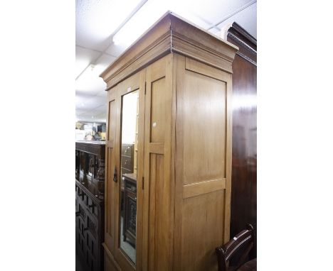 A SMALL SINGLE MIRROR DOOR LIGHT OAK WARDROBE WITH SINGLE DRAWER BELOW 