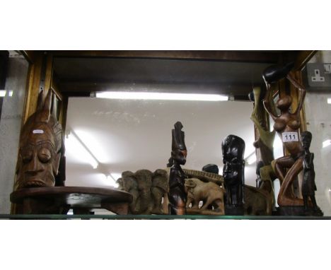 Shelf of ethnic treen figures