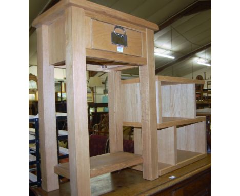 A modern light oak single drawer bedside table, together with a further light oak low book table (2)