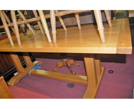 A contemporary light elm joined and planked top refectory table, having cleated ends and raised on twin chamfered square cut 