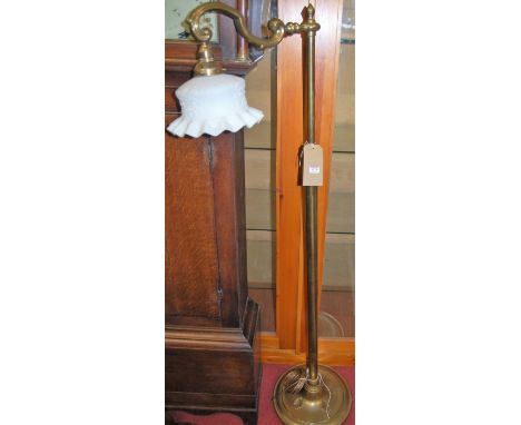 A Victorian style brass standard lamp, having milk glass handkerchief shade to single branch arm, with rotating action