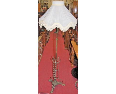 An Edwardian brass standard lamp, having a shaped and pleated shade