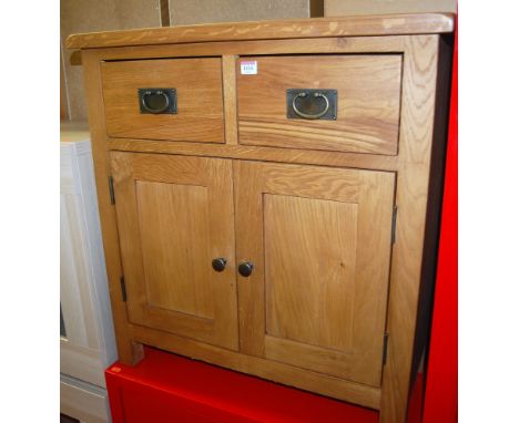 A contemporary light oak small double door side cupboard having twin upper drawers, width 75cm