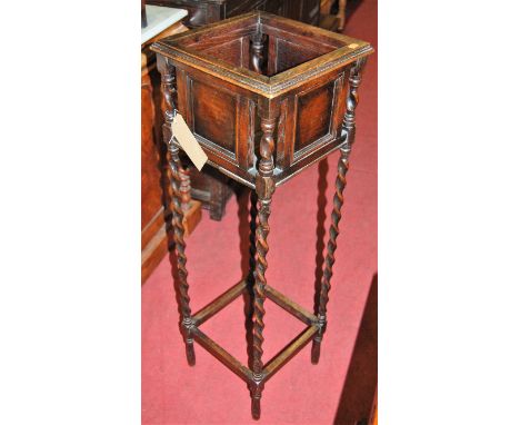 An early 20th century moulded oak square planter raised on barley twist turned supports, height 103cm