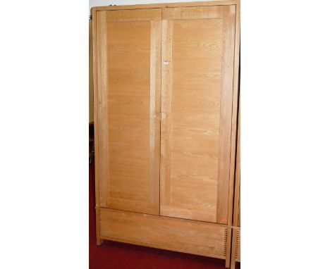 A good contemporary light oak double door wardrobe, having single long lower drawer, w.115cm