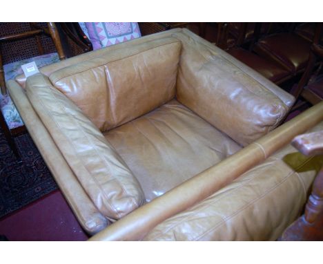 A Danish style light tan leather two-piece lounge suite, comprising two-seater sofa and single armchair, each by John Lewis, 