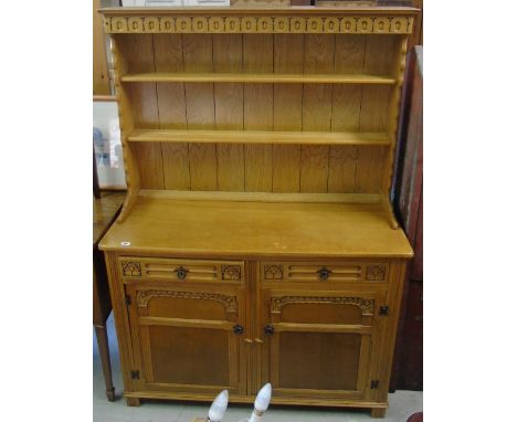 A Light Oak Old Charm Dresser; with two carved front drawers over two panelled cupboard doors and plate rack over.