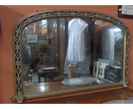 A Victorian Gilt Framed Overmantel Mirror of Arched Form, with running stylised floral detail raised on white glazed ceramic 