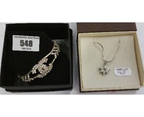 A Silver Coloured CoCo Bangle Along With A Silver Coloured Necklace.