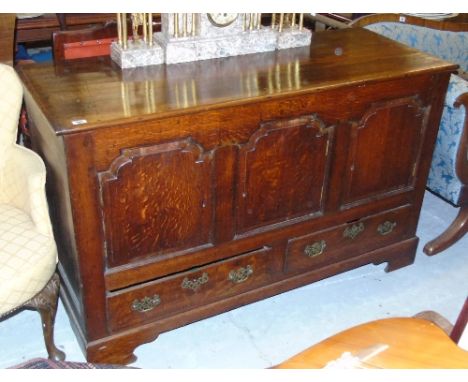 A George Third Oak Mule Chest; converted to a three door cupboard with two drawers to the base on bracket feet.