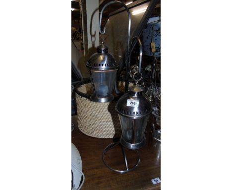 Three Hanging Tea-Light Lanterns on a Frame, along with a basket (2).