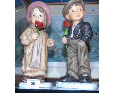A Pair of Goebel Figurines by Kim Anderson of a Boy & Girl Holding Red Roses. 9.5ins (2).