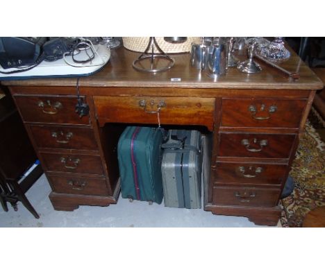 A George III Mahogany Partner's Desk of Neat Proportions, to each side a central drawer with four side drawers, an extension 