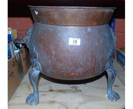 A Copper Planter Standing on Claw Feet and Having Lion Mask Handles.