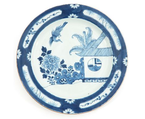 Depicting scene in garden with floral and bamboo decor border, circa 1800, 38 cm. in diameter, light fritting.